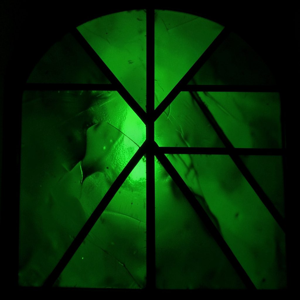 Dark teal and green abstract gradient background suggesting circuit board traces and glowing nodes, deep moody palette